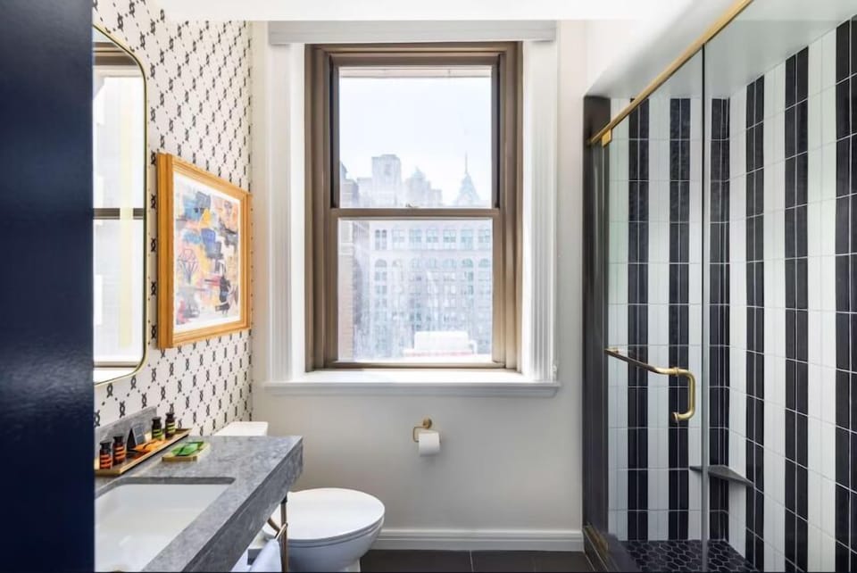 Enjoy skyline glimpses while getting ready in this airy bathroom.