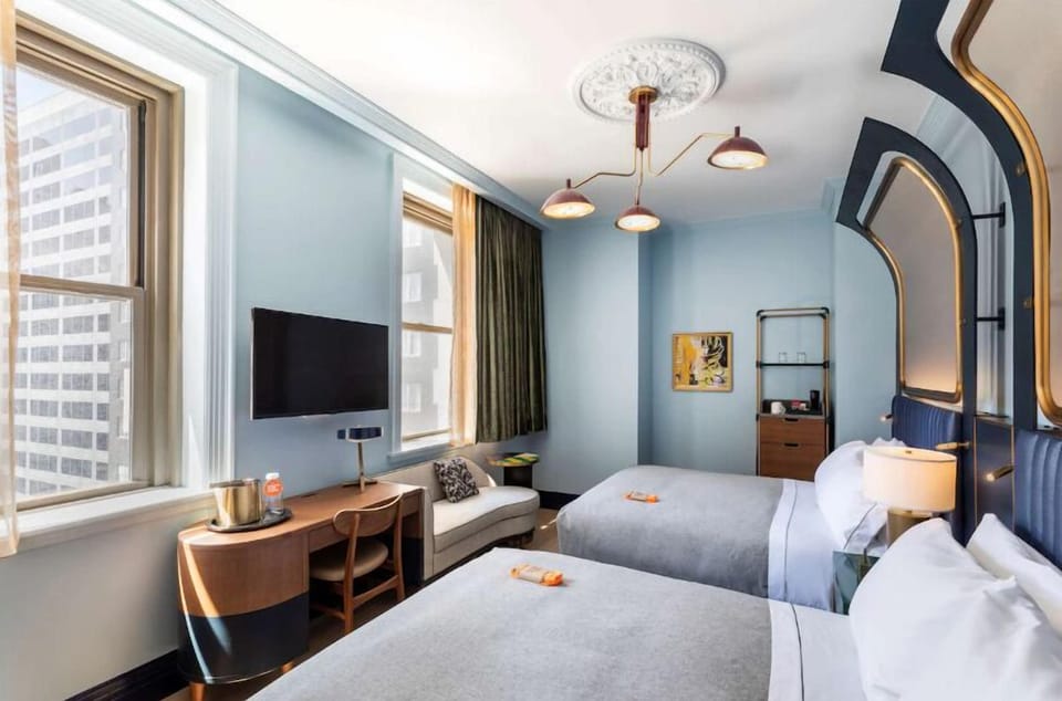 Settle into twin comfort with city views and a work desk.