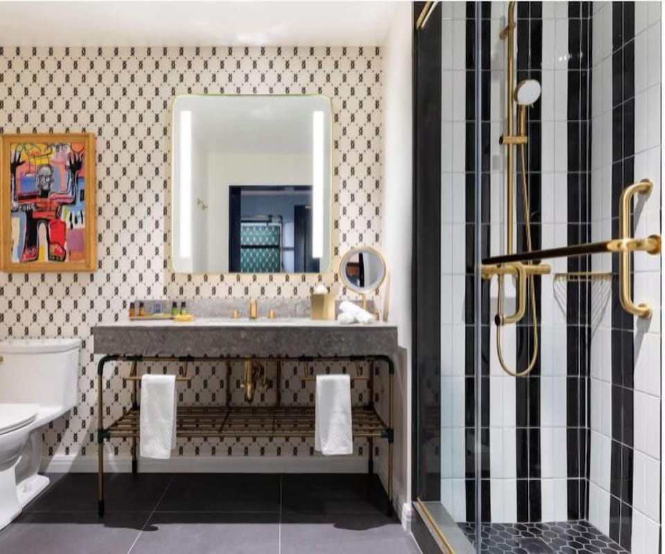 Indulge in a spa-like bath with striking tile and brass fixtures.