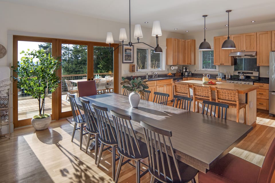 Table for 12 and additional seating at the kitchen island. Or dine on the deck.