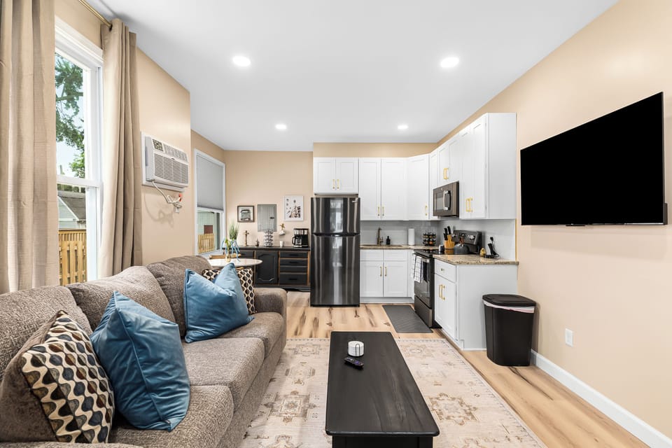 Relax in our inviting living room furnished with cozy seating and a smart TV for your entertainment.