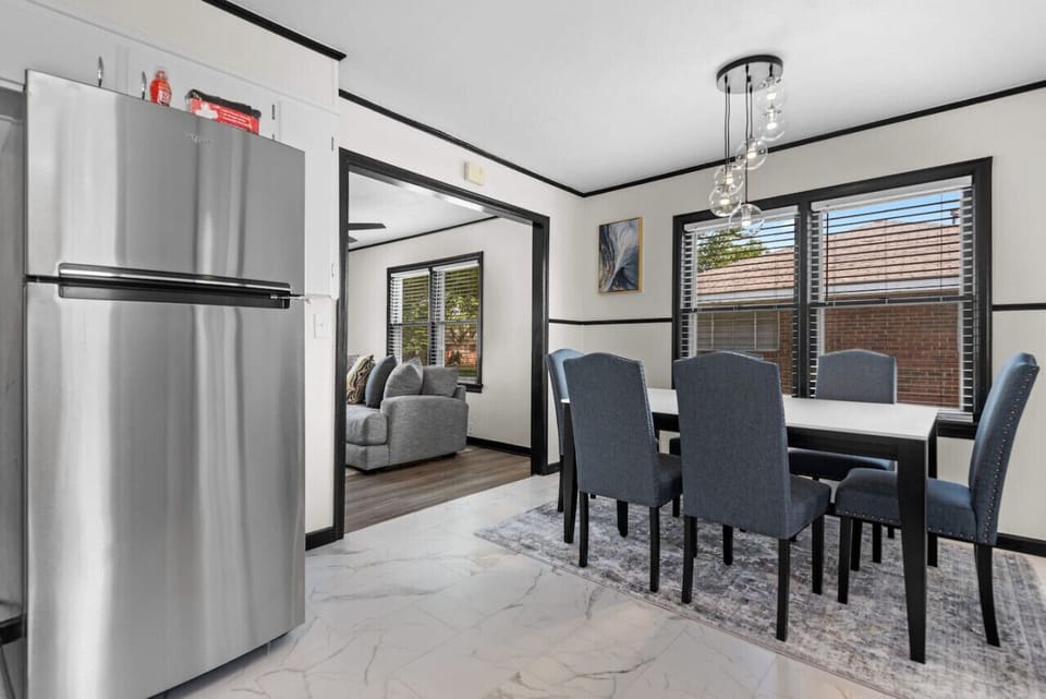 Flow seamlessly from the cozy living room into the elegant dining room and kitchen. Savor every moment in a space designed for togetherness and comfort. Discover more at Blessedbnbs.net.
