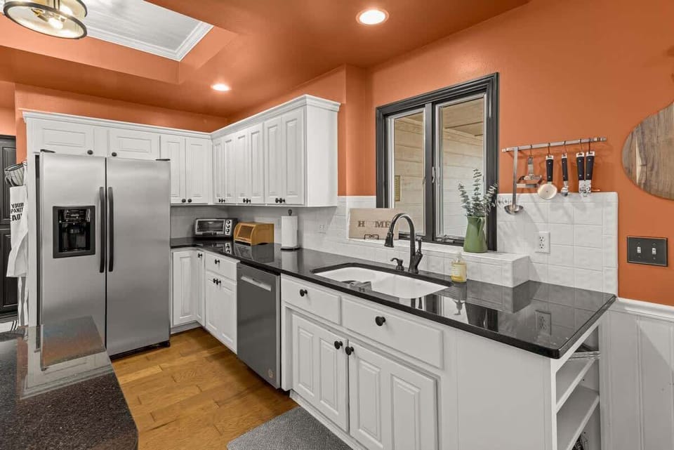 Elegance meets functionality in this stunning kitchen. With its white cabinetry and thoughtful design, it’s the perfect space for culinary creativity and cherished moments. 