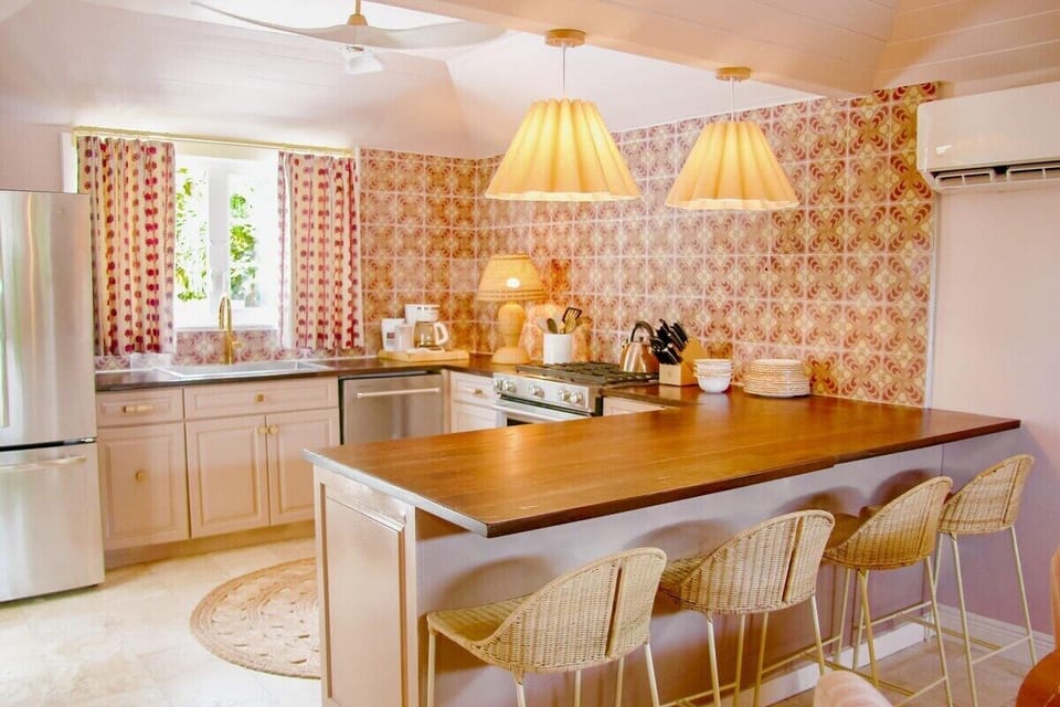 Modern appliances including refrigerator with freezer, gas stove, oven, wine cooler, beverage cooler, dishwasher and conventional coffee maker.