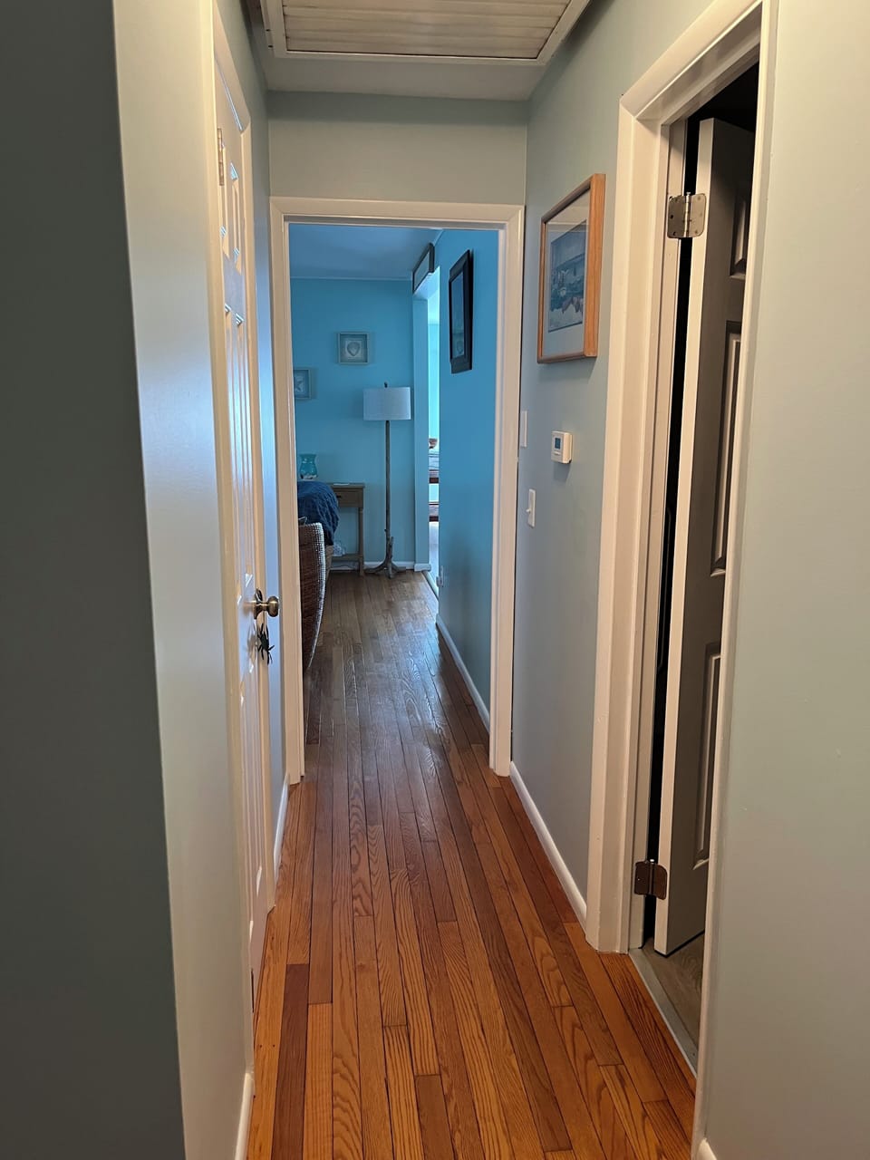 Hallway leading away from bedrooms, main bathroom on the right