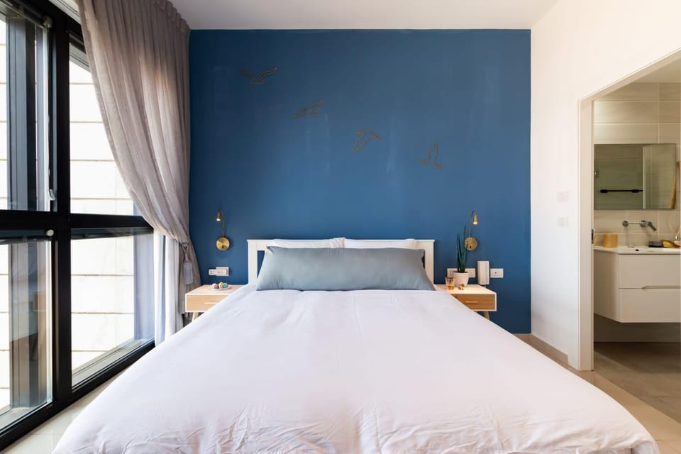 Wake to panoramic sea views framed by soft curtains, bringing peaceful mornings just steps from beach.