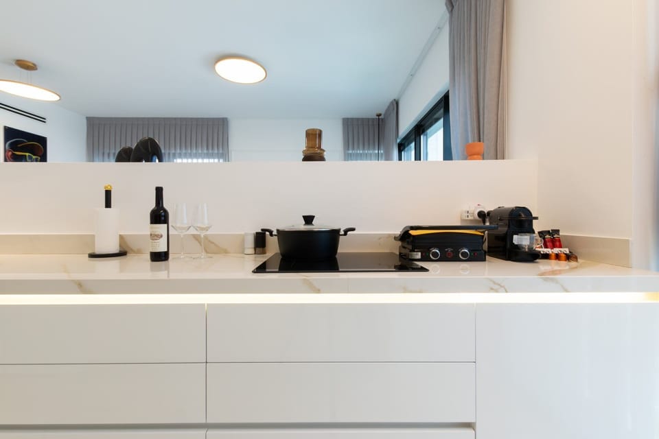 Sleek countertop setup with appliances ensures practical convenience, enhancing smooth daily routines during stays.