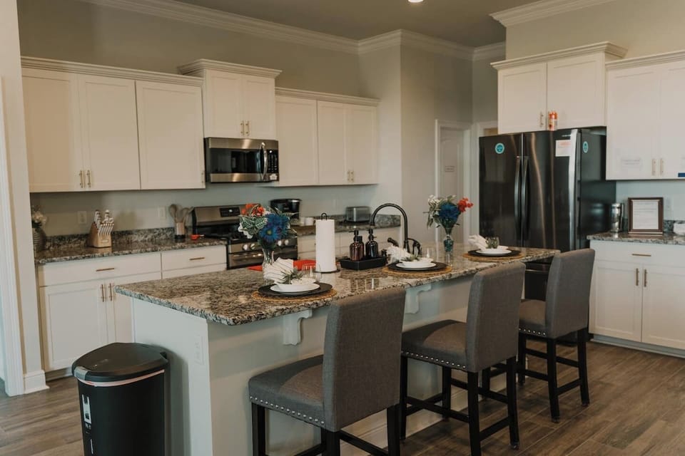 The convenient full kitchen comes equipped with all essentials for providing home cooked meals. The large island creates a great option for dining in a less formal setting. 