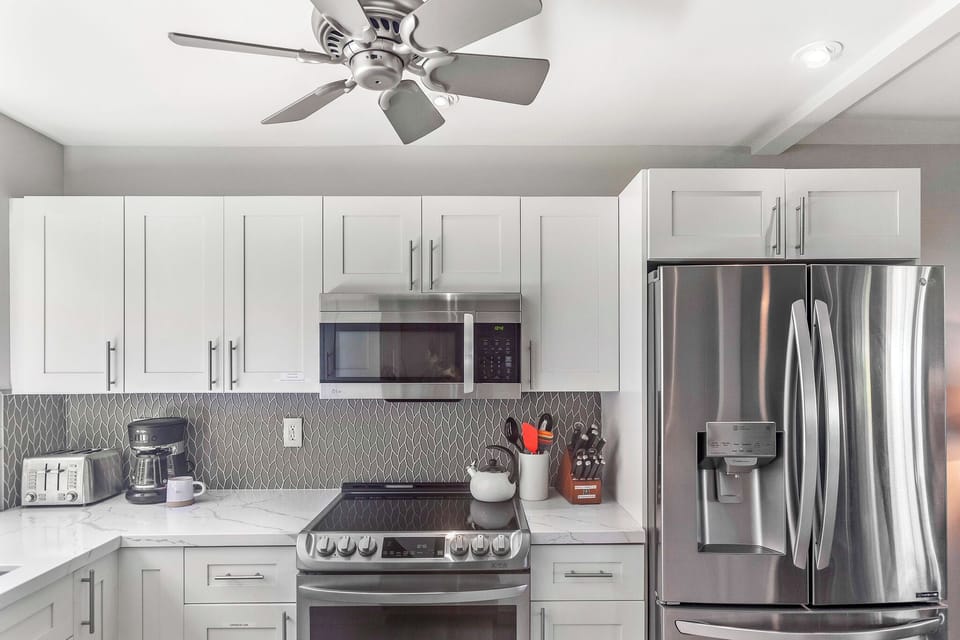 Well stocked kitchen with glass top range, full refrigerator and ceiling fan!