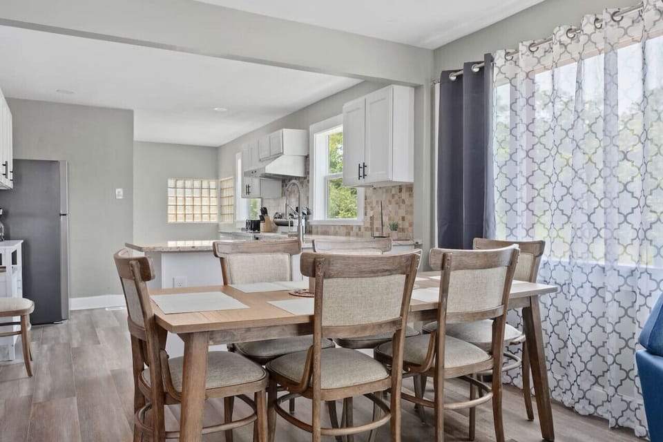 Cozy dining nook with seating for four, surrounded by natural light – an inviting spot for meals or morning coffee