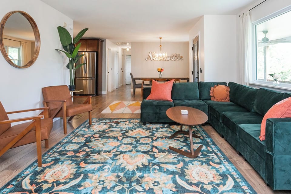 Living room open to the house, 65" TV, wood burning stove, seat big groups