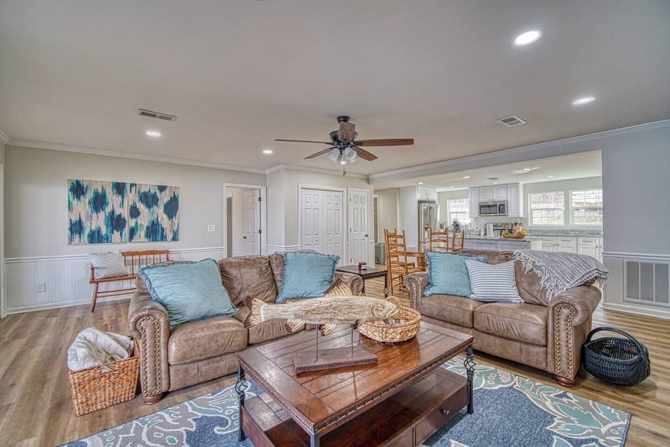 Spacious living room with comfortable sofas, smart tv, and gas logs. 