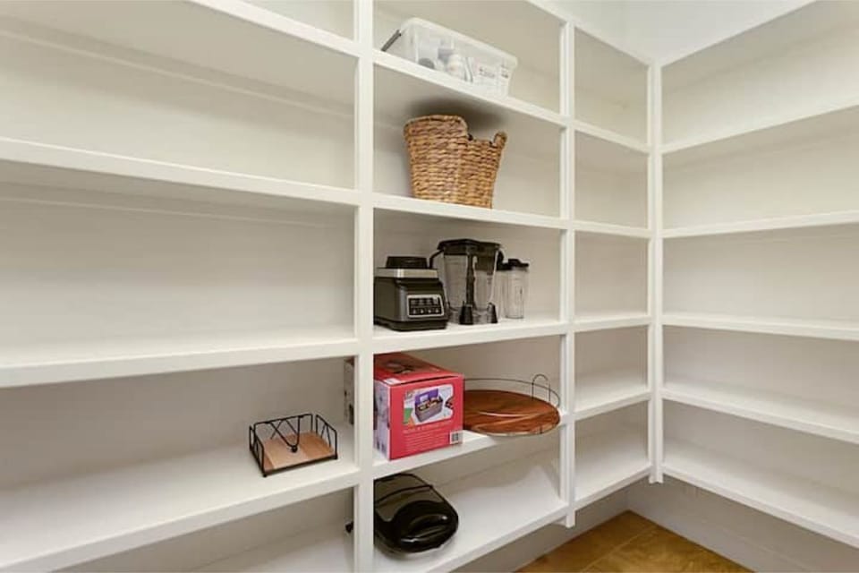 Generous pantry off of the kitchen with plenty of shelf space.