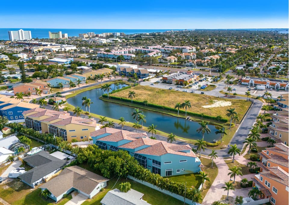 Aerial view of a coastal community with lagoon and nearby shoreline.