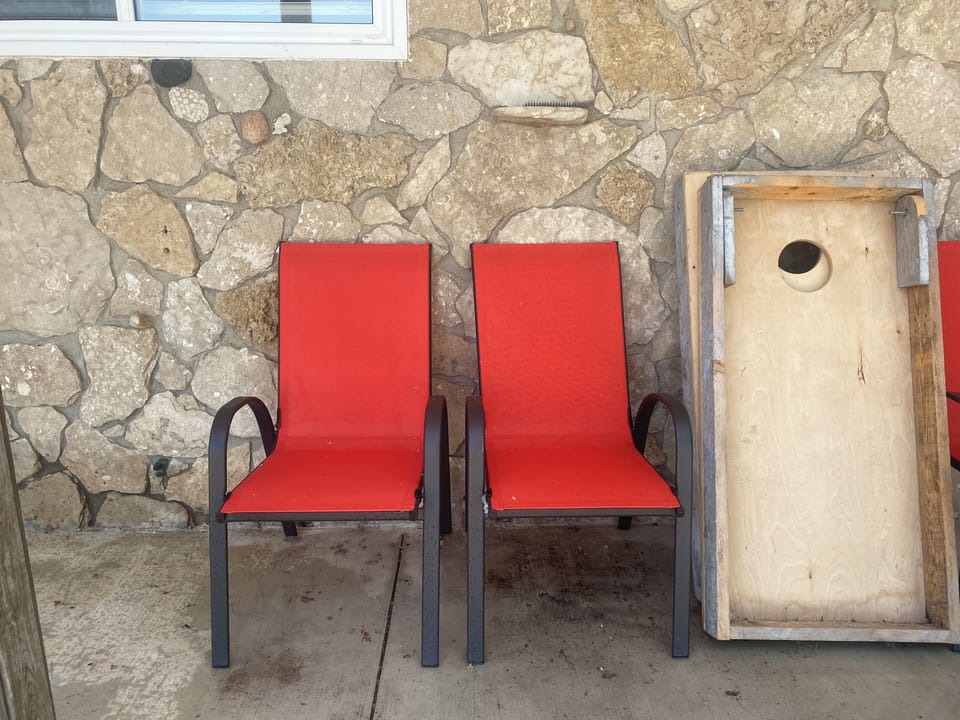 Covered seating and cornhole game