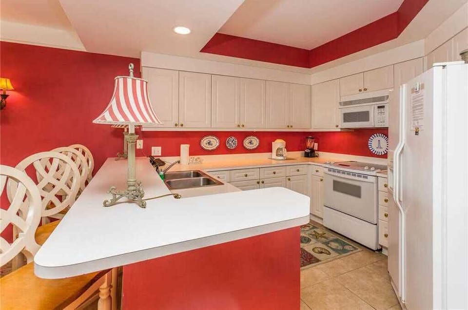 St. Simons Grand #113 Kitchen with French Door Refrigerator, Electric Stove, and Over-the-Range Microwave