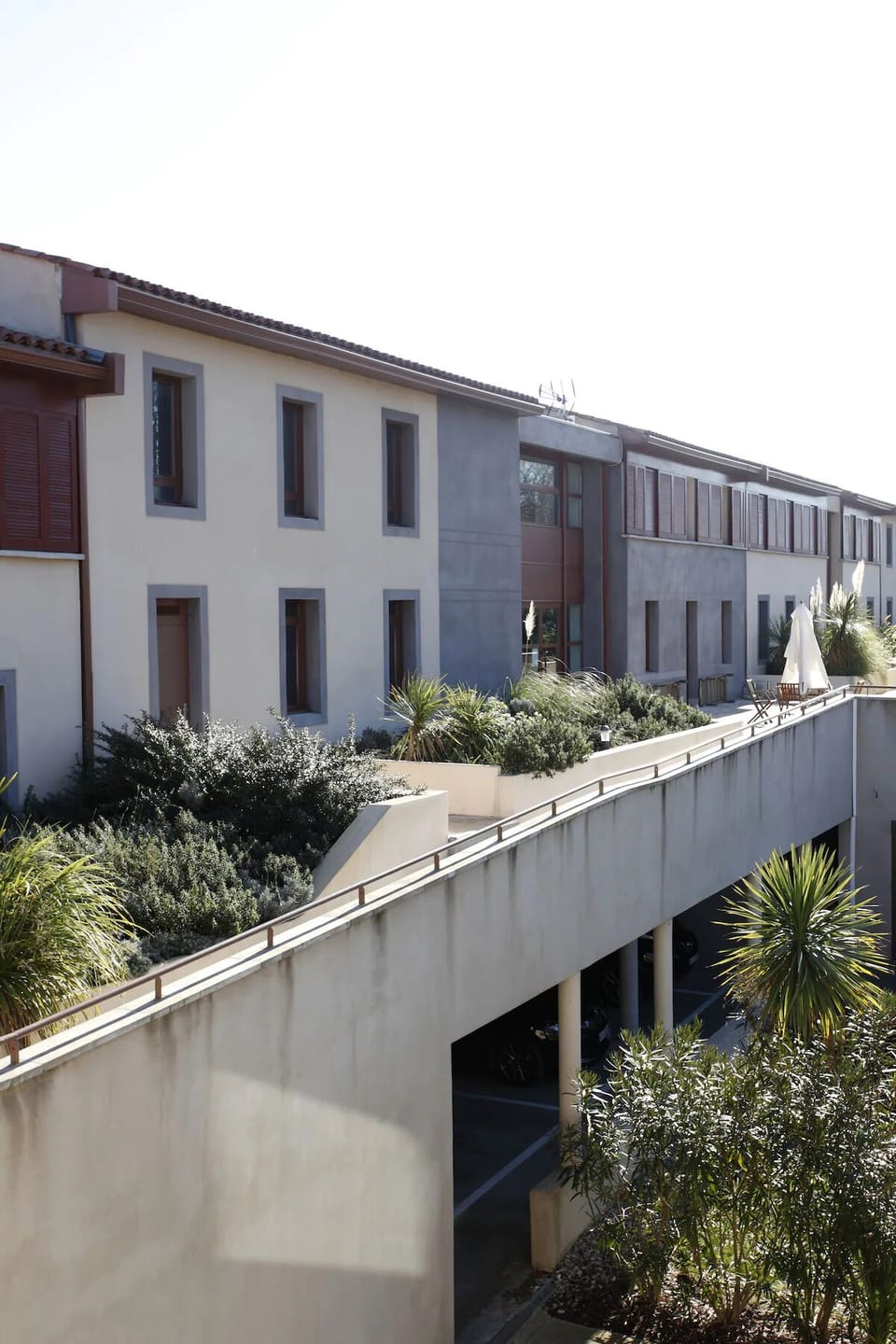 Stroll along bright walkways framed by lush Mediterranean greenery.