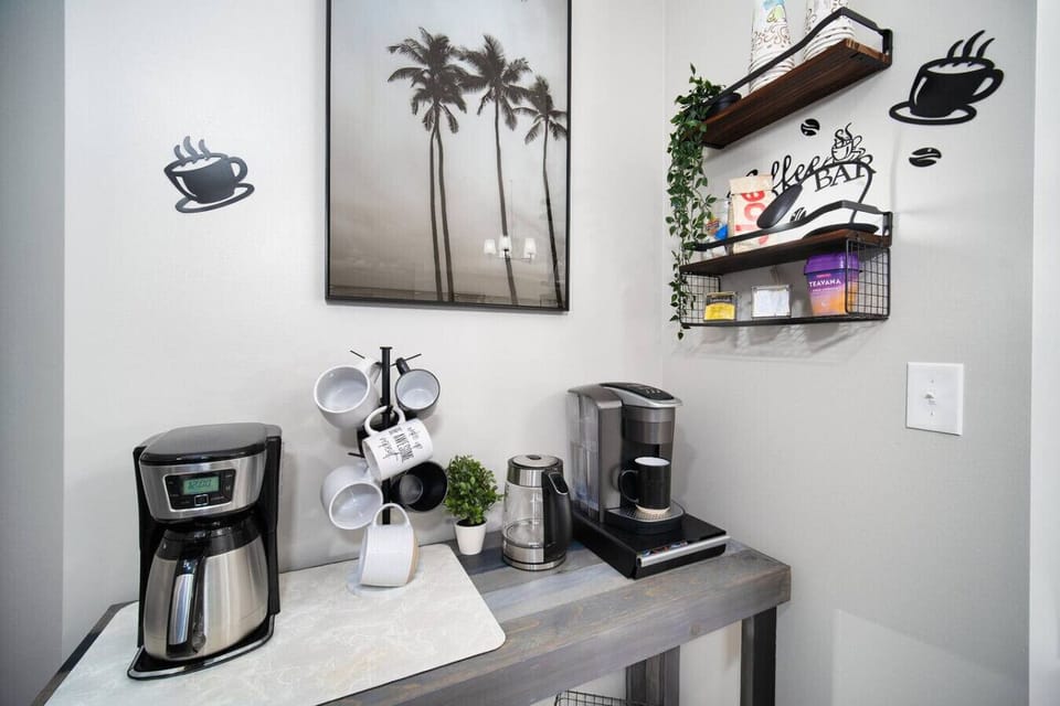 Charming coffee bar area with a variety of brewing options and cozy decor.