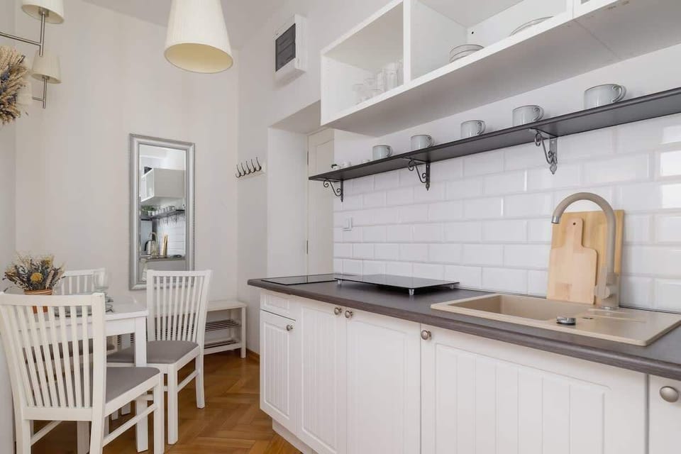 A sleek and modern kitchen with white cabinetry and a minimalist design.