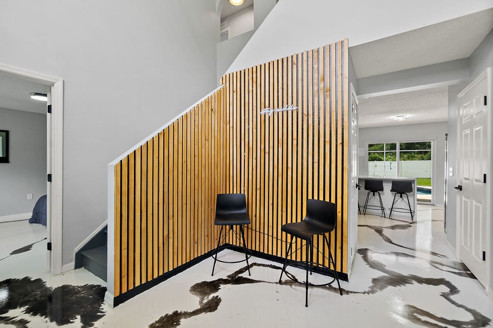 Capture Instagram-worthy pics at this trendy backdrop with seating and LED sign "Stay Awhile"