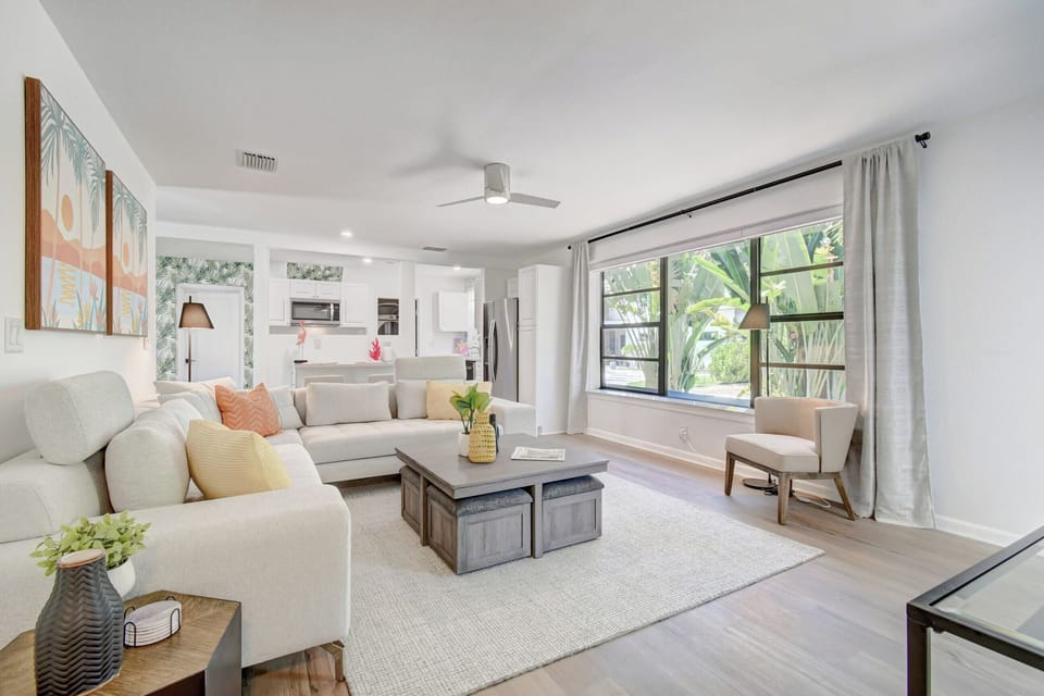 Discover luxury in Delray Beach with our open living room, boasting high-end furnishings and a cozy side chair for ultimate relaxation.