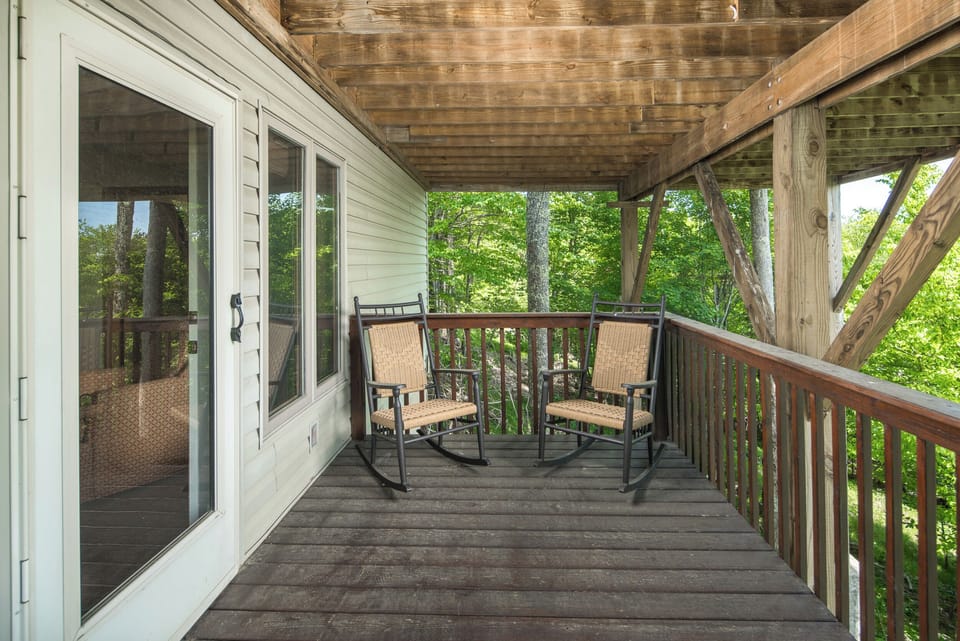 Peaceful deck with two rocking chairs.