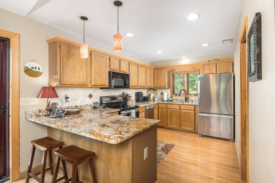 Spacious kitchen with granite countertops.