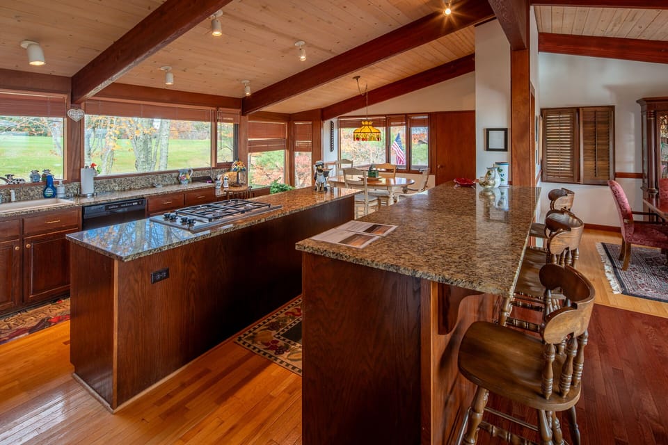 Kitchen with granite countertops, breakfast bar, and dining area.
