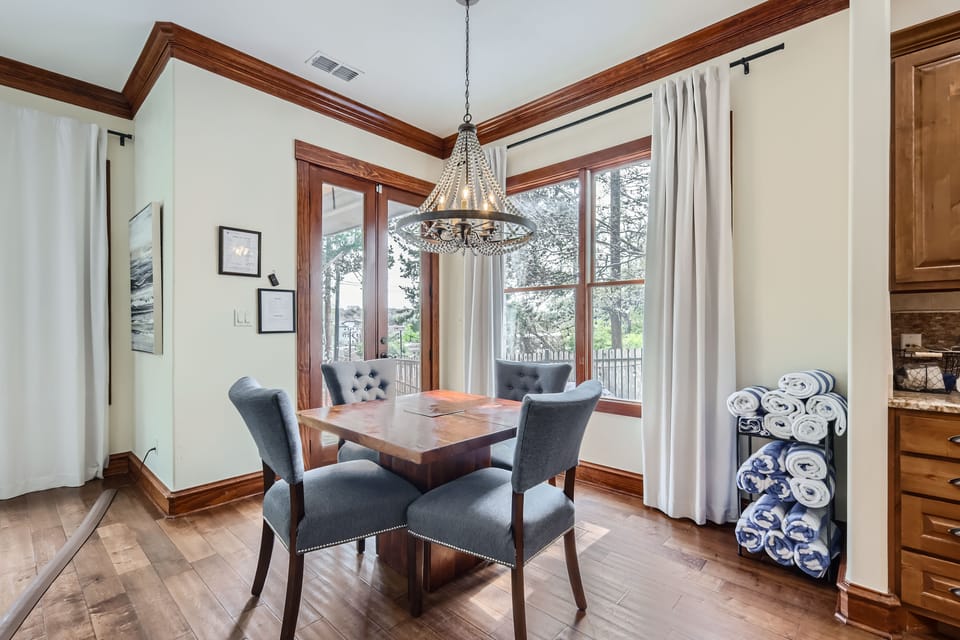 The door behind the table and chairs leads to the pool and hot tub.
