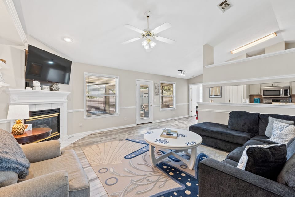 Large open living room with sleeper sectional, accent chair, and smart TV.