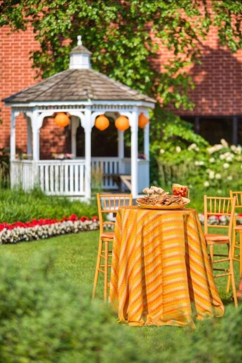 Sip cocktails outdoors beside the charming gazebo and lush gardens.