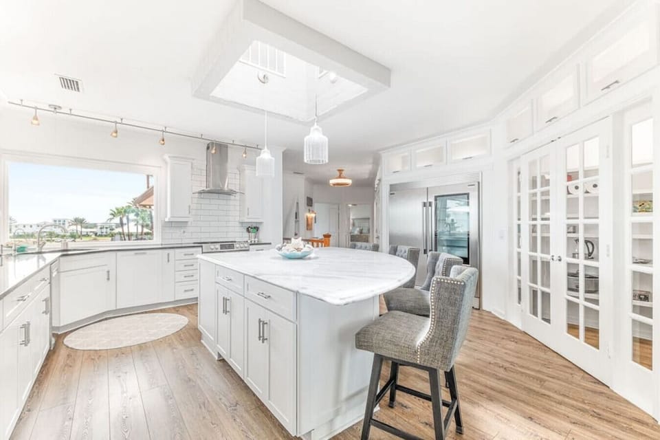 The incredible kitchen and walk-in pantry.  The skylight above the island provides plenty of natural light.  You can even see the ocean from the comfortable bar chairs.