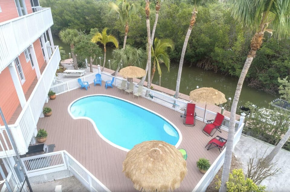 Pool with private canal and dock in background.