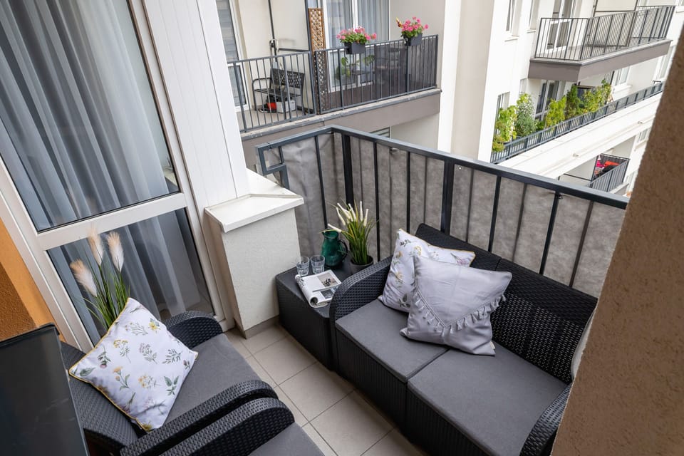 A closer look at the balcony, featuring decorative details and inviting seating for enjoying the fresh air.

