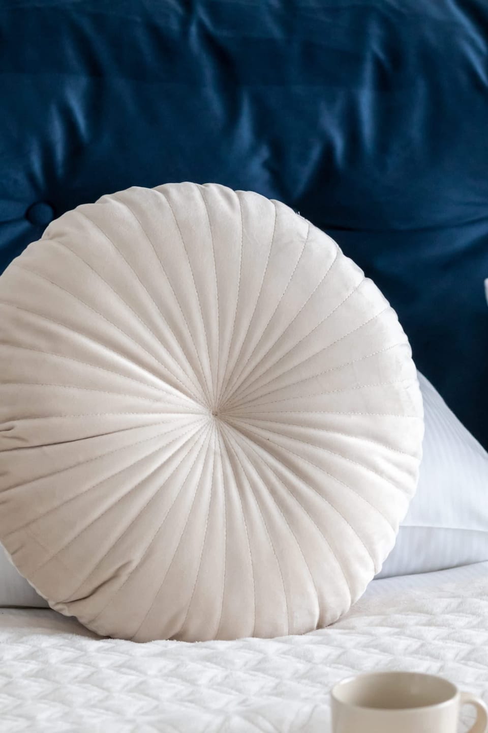 A close-up of a decorative pillow on the bed, adding texture and elegance to the bedroom design.

