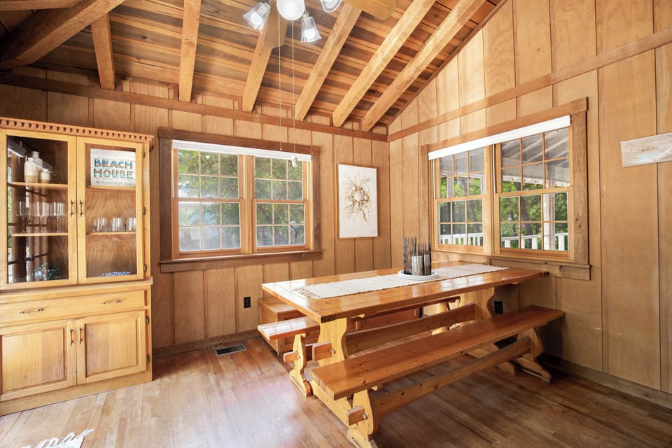 Gather around this handcrafted wooden dining table where rustic charm meets modern comfort in your cozy retreat.