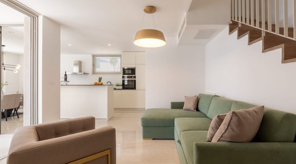 A spacious living room with a comfortable sofa bed for two additional people inside a private luxury villa