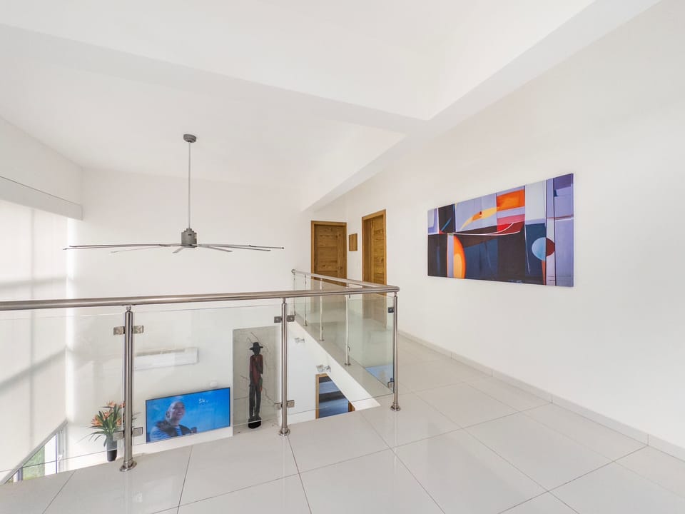 Second level with 2 bedrooms, media area, air hockey table and balcony