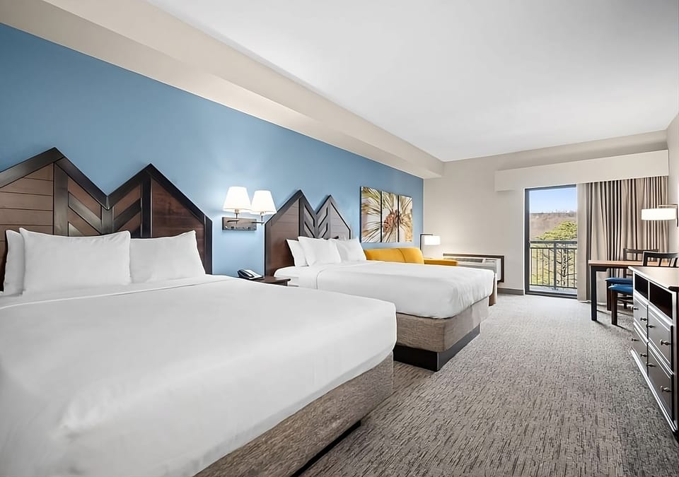 Unwind in bright double-queen comfort with balcony views.
