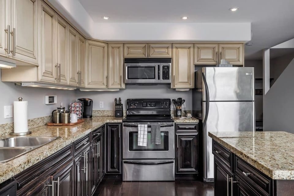 Fully stocked kitchen with stainless steel appliances.