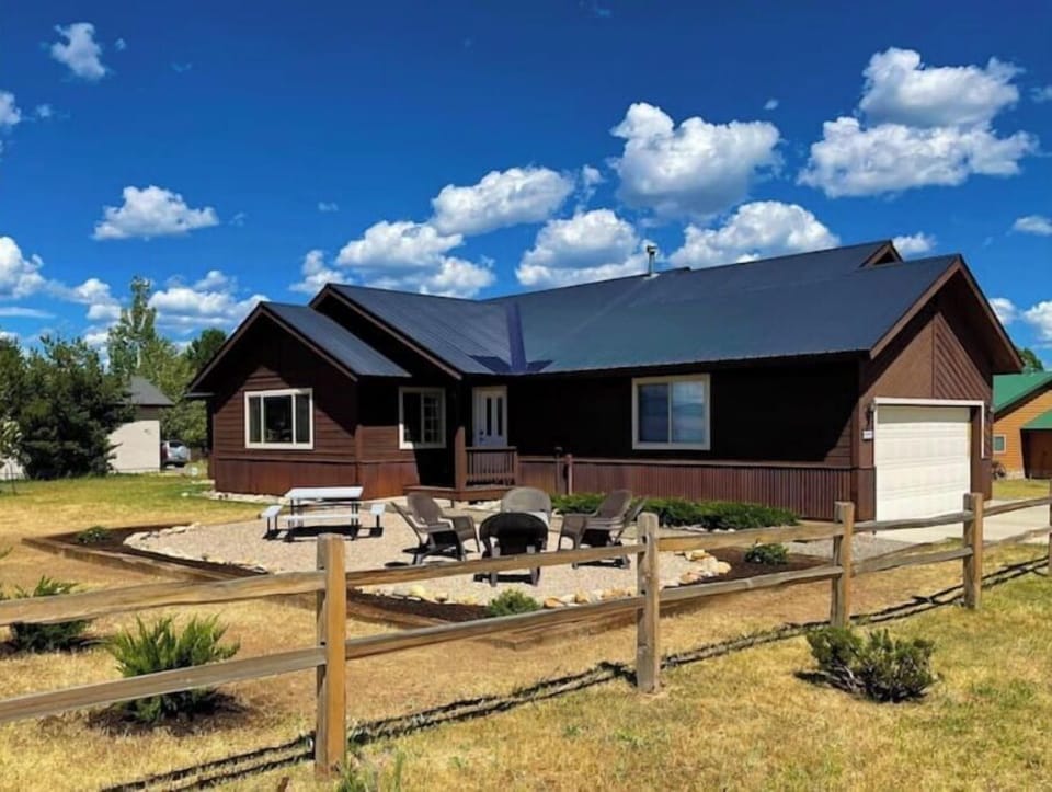 Front view. Picnic table seating & firepit area.