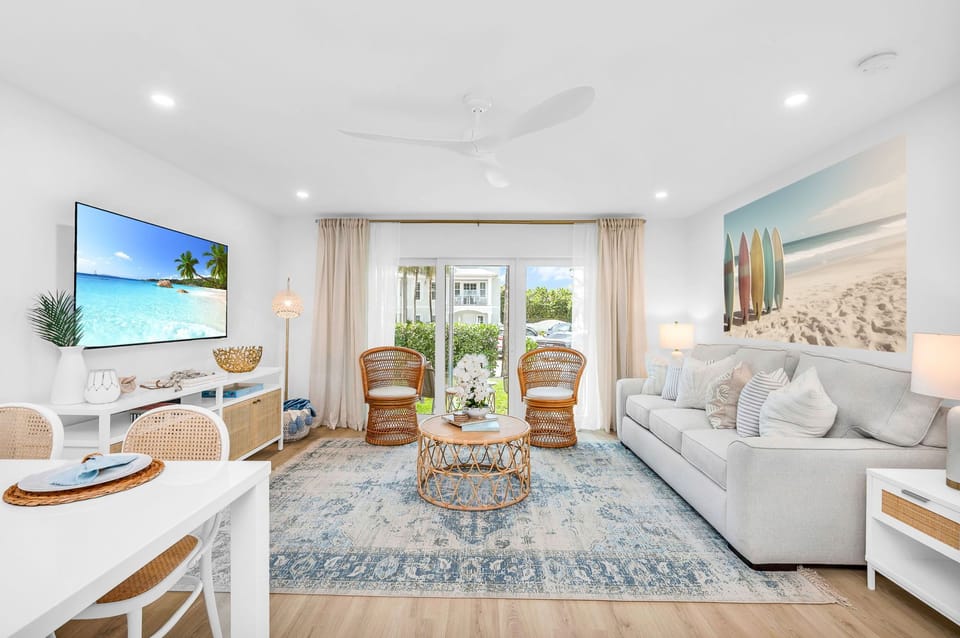 This designer living room is an open space for family and friends to share conversation, play "Florida-poly" or the Gray Malin Backgammon board, read an array of coastal and tropical books, or enjoy your favorite shows on the large 65" TV.