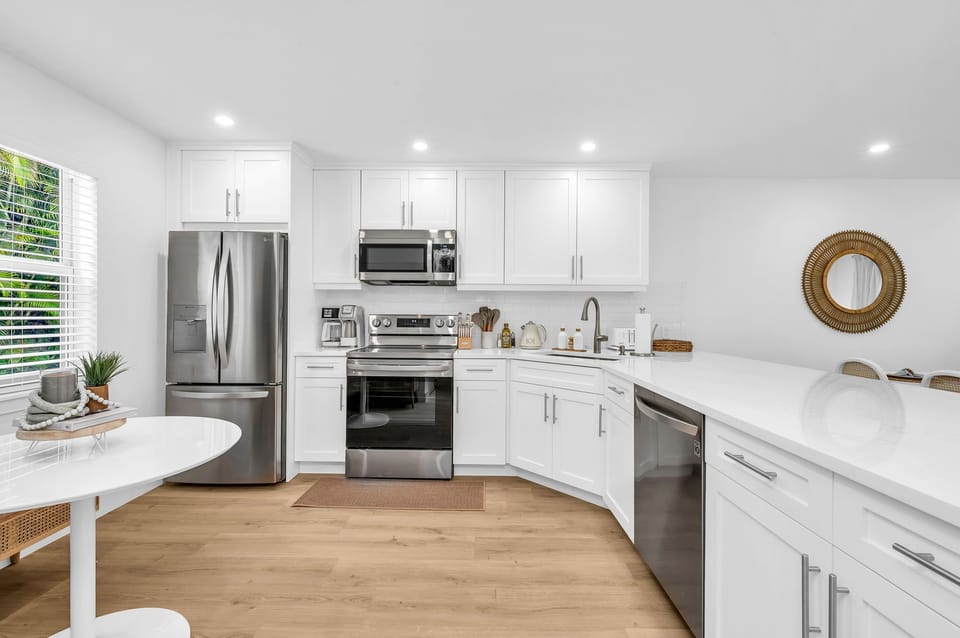 A beautifully designed spacious and modern kitchen with white shaker cabinets, marbled quartz countertops, stainless steel appliances, ice maker and fully equipped with everything you need to serve 6 - 8 guests.