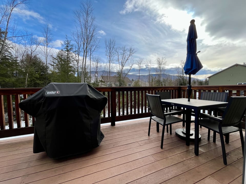 Deck with grill and outdoor dining table.