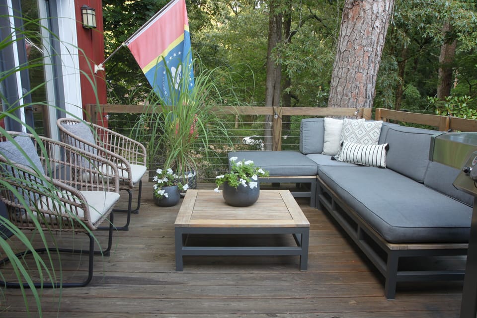 Front deck with large seating area and gas grill. 