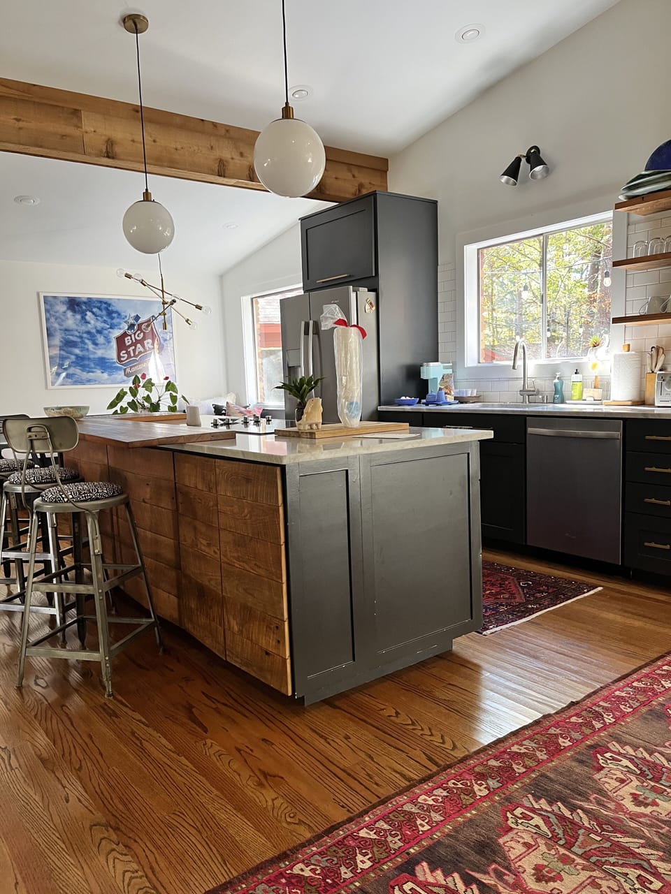 Fully stocked kitchen with coffee and snacks. Open to living and dining areas.