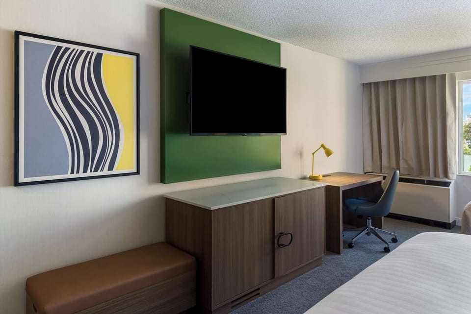 Work comfortably at the desk beside daylight and blackout drapes.