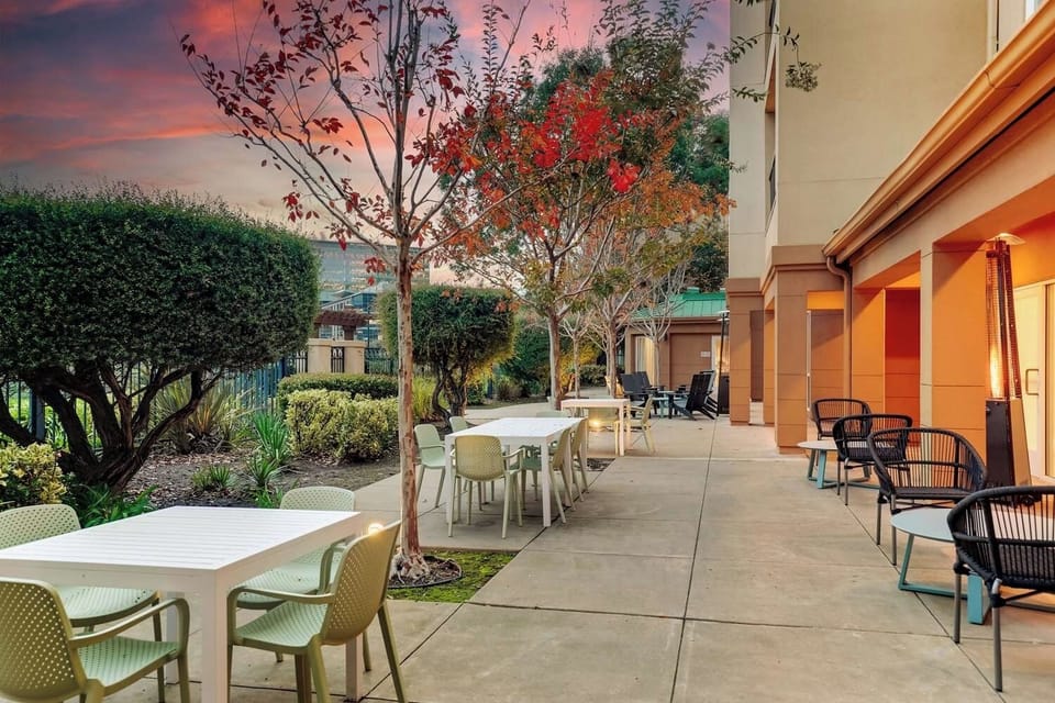 Enjoy al fresco meals surrounded by greenery and warm lighting.
