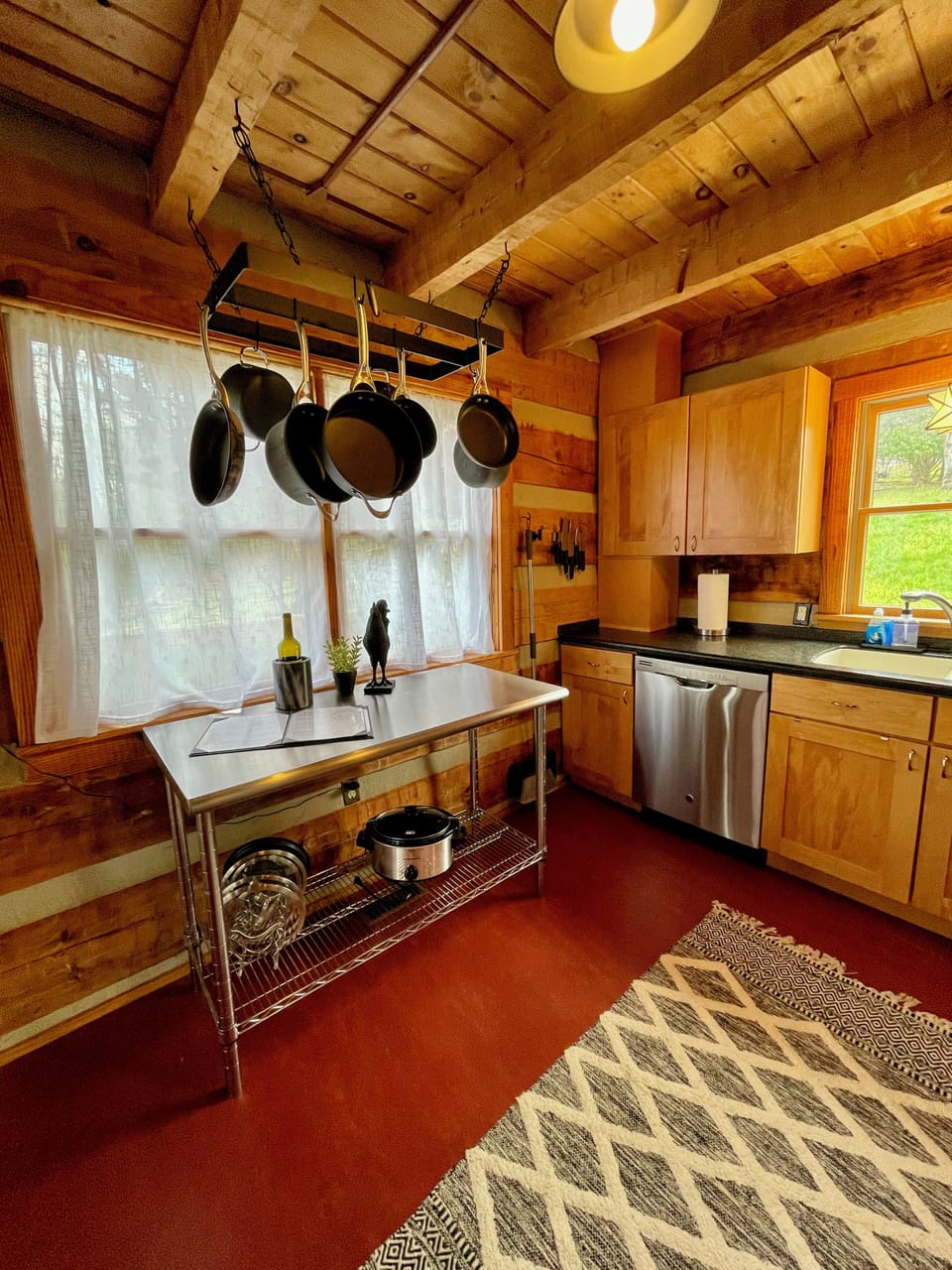 Fully-stocked kitchen with gas range, dishwasher, and ample cookware and dishes.