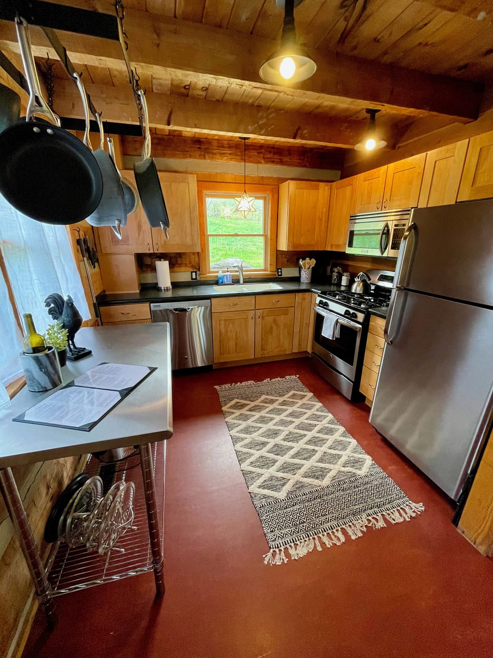 Fully-stocked kitchen with gas range, dishwasher, and ample cookware and dishes.